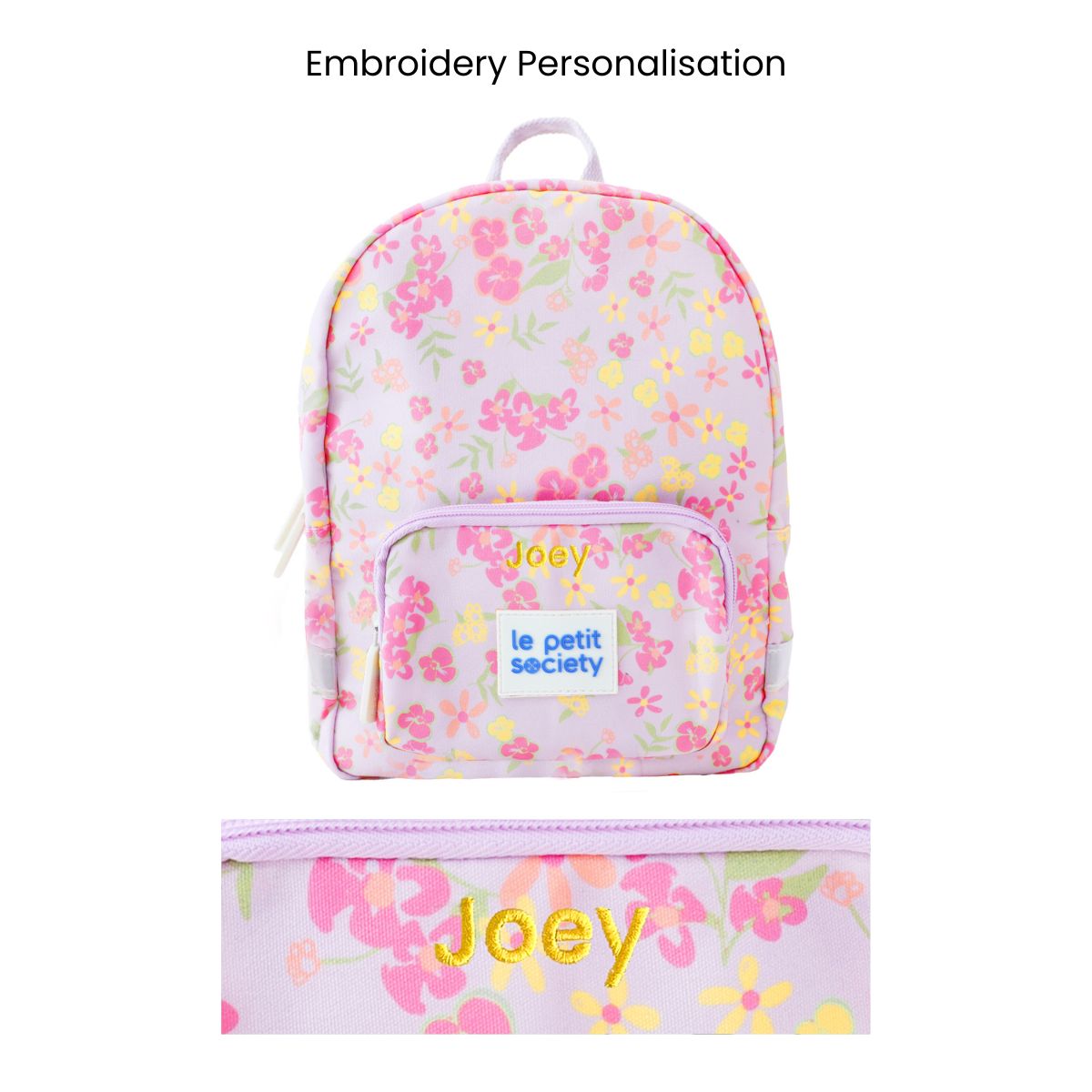 A purple preschool bag with a pink and yellow floral print and personalised name embroidery.