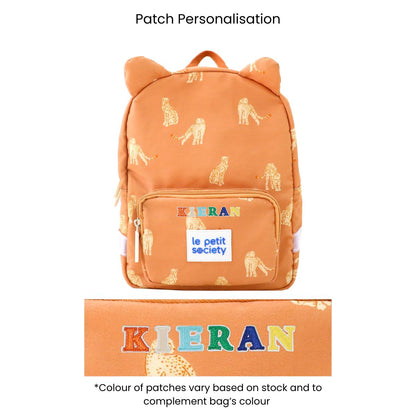An orange preschool bag with a leopard print and personalised name patches.