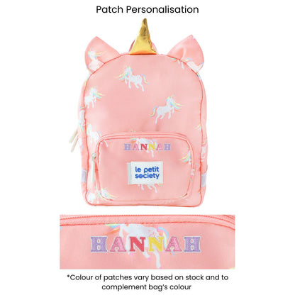 A pink preschool bag with a unicorn print and personalised name patches.