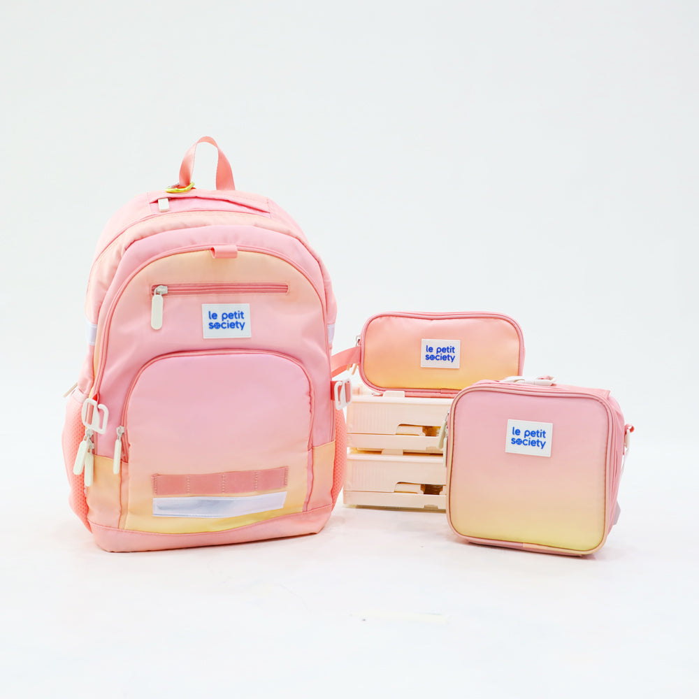 The LPS kids essential school bundle in a pink and yellow ombre, consisting of a school bag, mini lunch bag and pencil case.