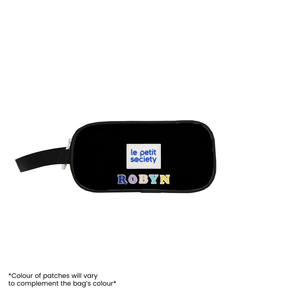 A black pencil case personalised with colourful name patches.