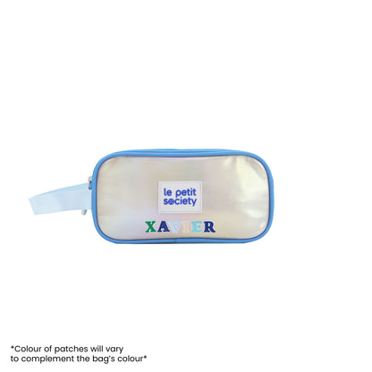 An iridescent blue and silver pencil case with personalised name patches.