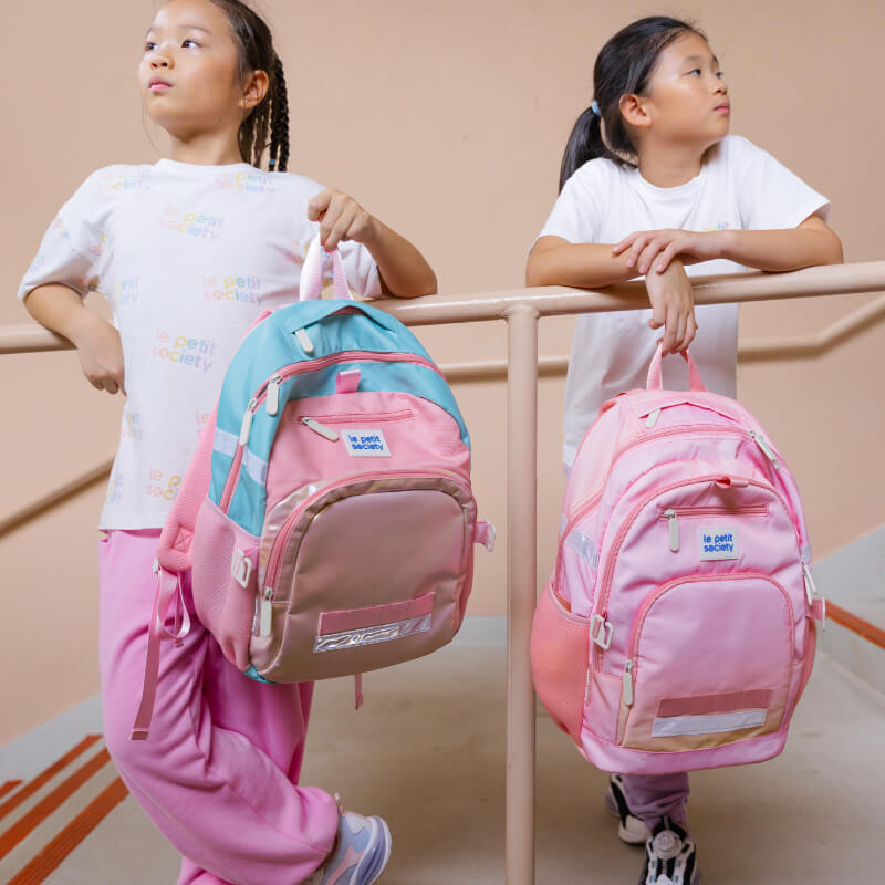 Two primary school girls with Le Petit Society's kids school bags.