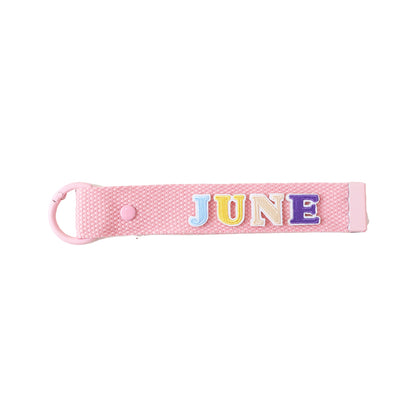 Le Petit Society's pink bag tag customised with name patches.