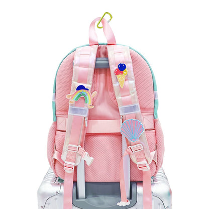 The straps of a school bag personalised with sticker patches.