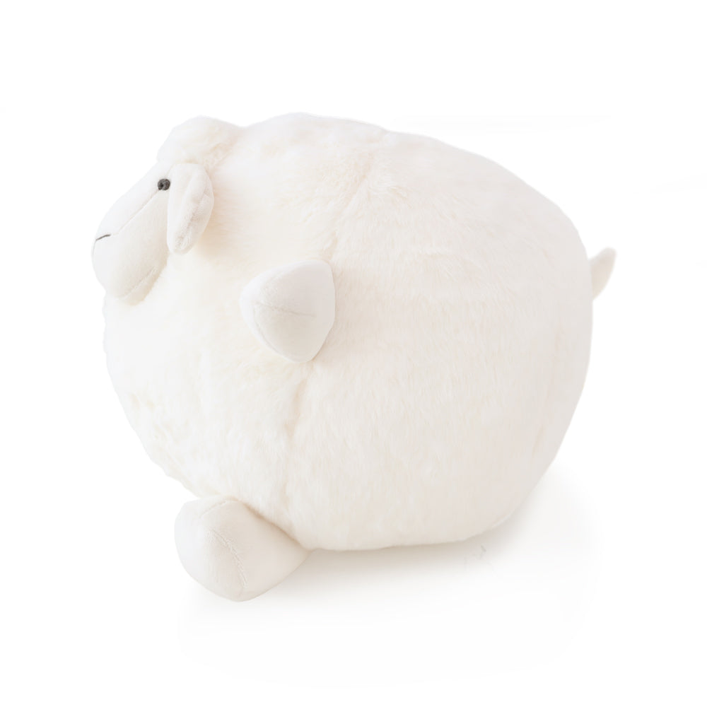 A side view of a round and plush sheep toy in cream white by Le Petit Society against a white background.
