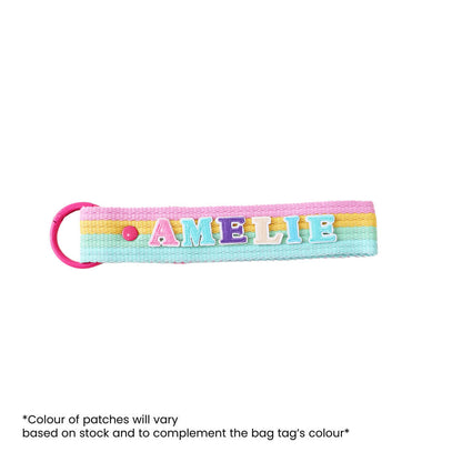 A rainbow-coloured bag tag customised with name patches from Le Petit Society.