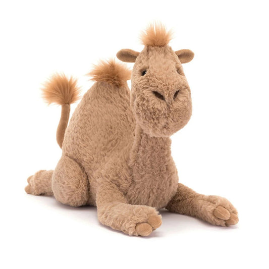 A front view of a plush camel styled as Jellycat‚Äôs Richie Dromedary: soft sandy-brown fur, a pronounced hump, embroidered nostrils, a poised tail, cloven hooves, and a gentle smiling expression.