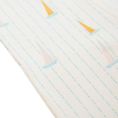 A close-up of the sail boat print of Le Petit Society's baby organic zip sleepsuit.