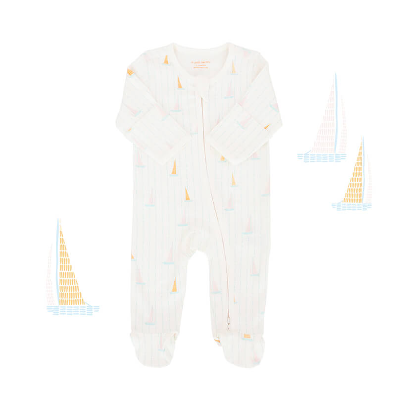 An organic baby zip sleepsuit from Le Petit Society. It is white in colour with a print of sail boats and foldable mittens and footies.