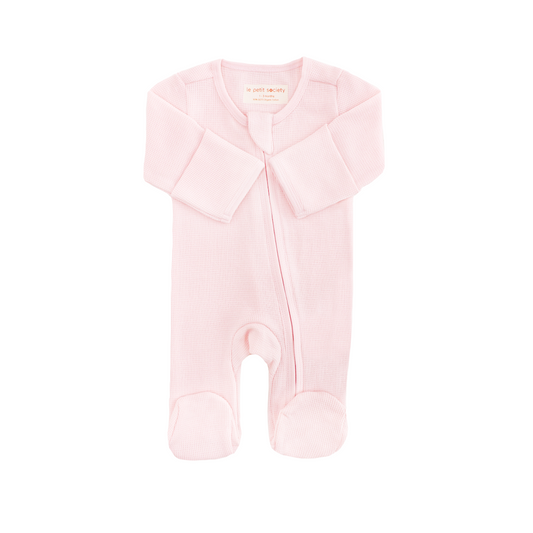 An organic baby zip sleepsuit in pink by Le Petit Society.
