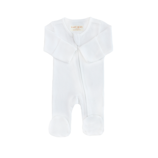 An organic baby zip sleepsuit in white by Le Petit Society.
