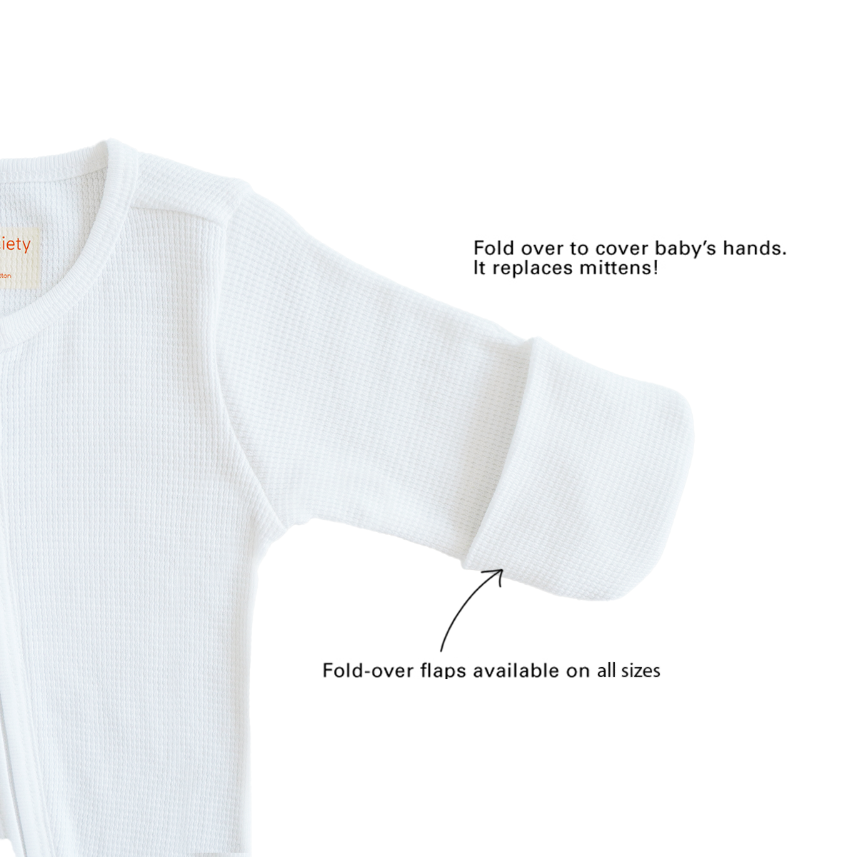 A baby organic zip sleepsuit in white by Le Petit Society, with fold over flaps at the sleeves to cover a baby's hands, acting as a substitute for mittens.
