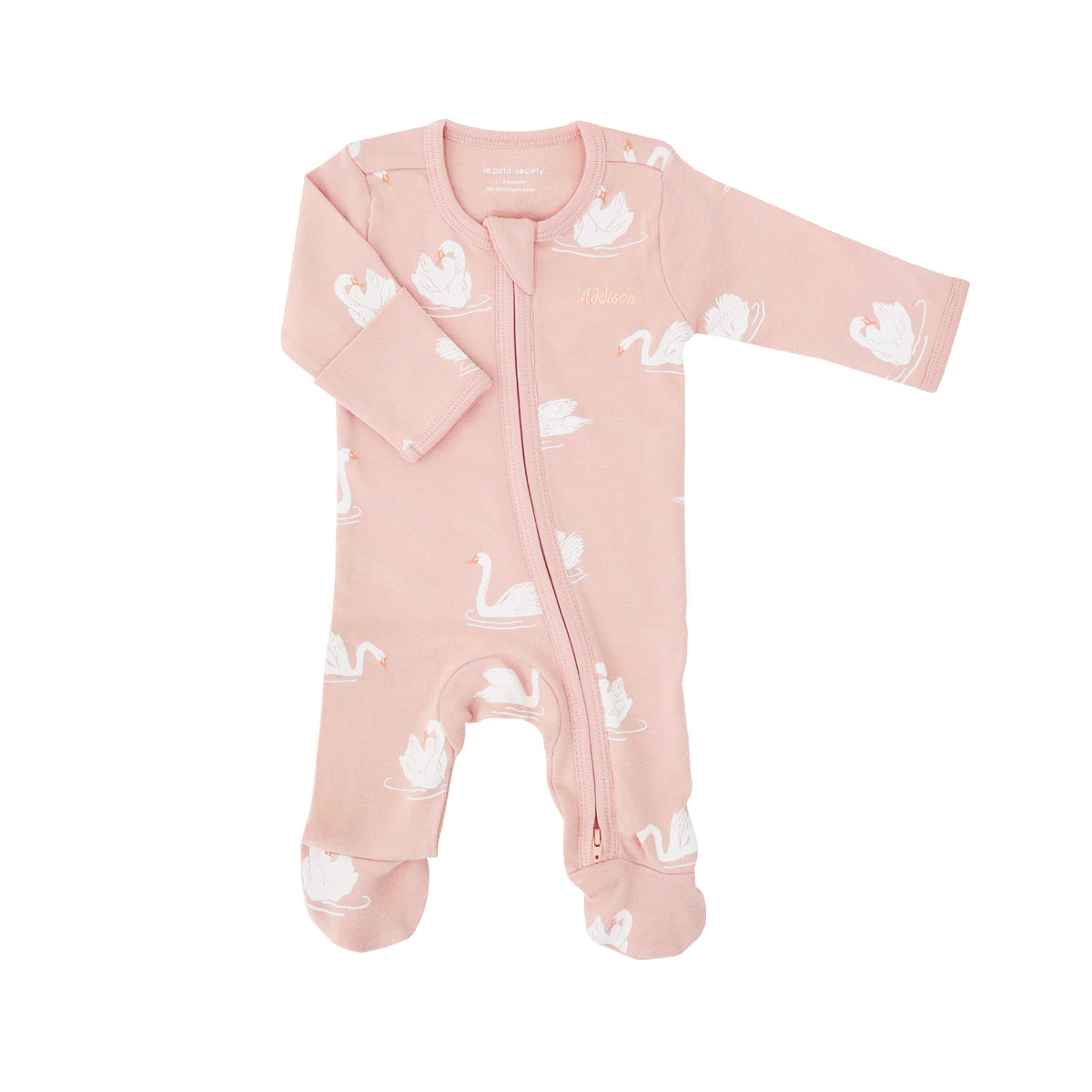 A baby organic zip sleepsuit in peach with foldable mittens and footies by Le Petit Society, featuring a print of swans.