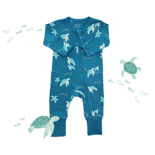 An organic baby zip sleepsuit from Le Petit Society. It is blue in colour with a print of turtles and foldable mittens and footies.