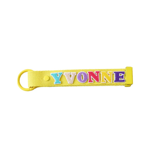 Le Petit Society's yellow bag tag customised with name patches.