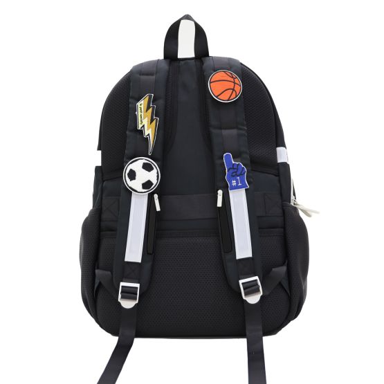 The shoulder straps of a Le Petit Society school bag customised with velcro patches.