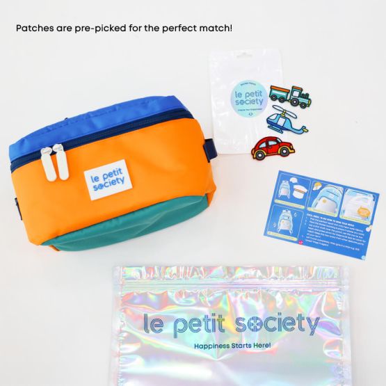 A blue and orange thermal lunch bag and sticker patches of vehicles for personalisation from Le Petit Society's customisable party pack.