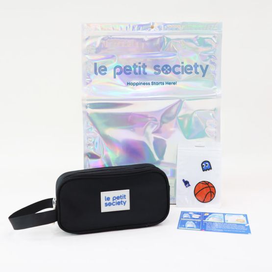 Le Petit Society's customisable party pack, with a black pencil case and sticker patches for personalisation.