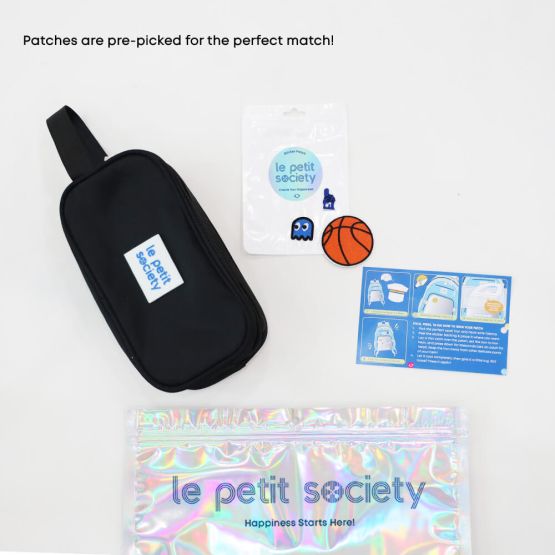 A black pencil case and sticker patches for personalisation from Le Petit Society's customisable party pack.