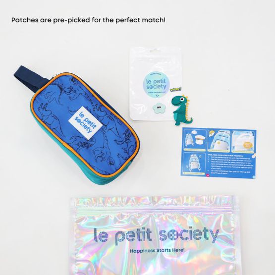 A blue and orange pencil case with a dinosaur print and dinosaur themed-sticker patches from Le Petit Society's customisable party pack.