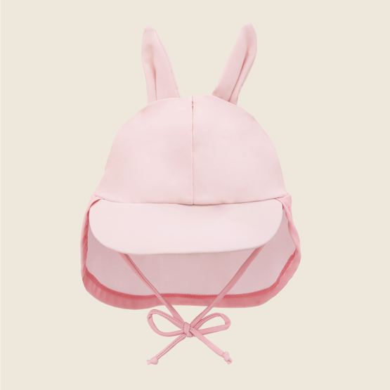Baby Bunny Sunhat front view with bunny ears, sun visor, and adjustable chin tie in soft pink