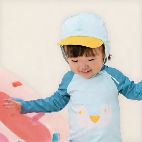 Baby Penguin Sunhat front view with yellow visor, neck flap, and adjustable chin tie in light blue