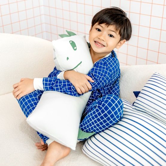 The back of a kids' bamboo pillow with a green dinosaur design in medium by Le Petit Society.