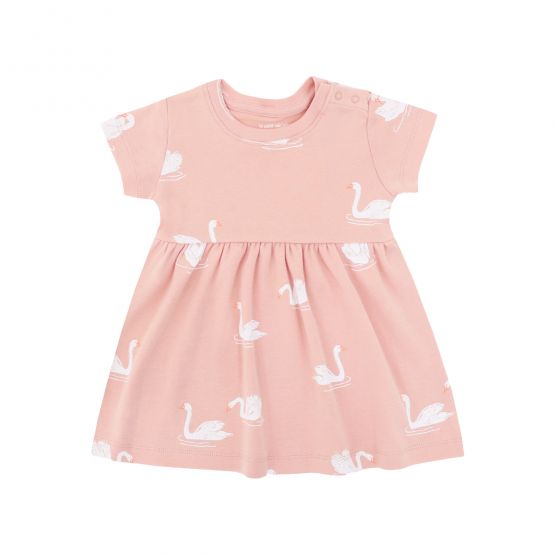 A peach-coloured, girl's organic dress adorned with a print of swans from Le Petit Society.
